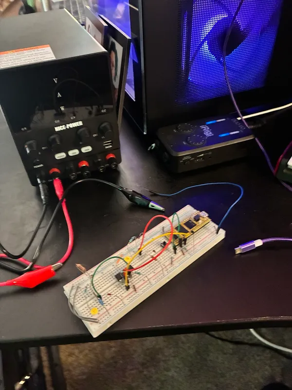 Breadboard prototype on a bench power supply with clip leads